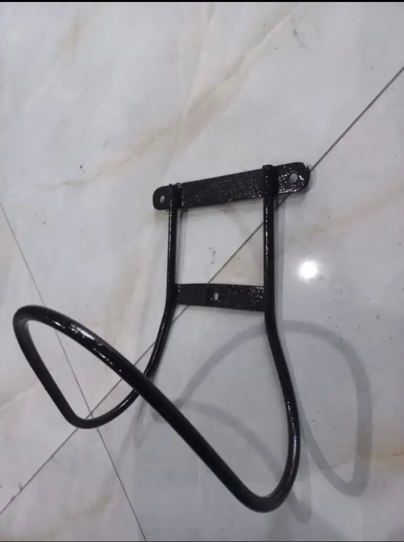Black metal bike rack on a white tiled floor