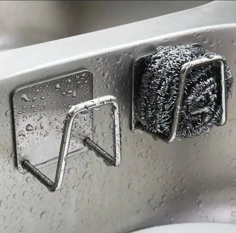 Metal scrubber and holder attached to a kitchen sink