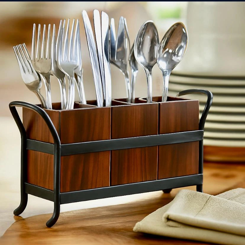 Wooden cutlery holder with silverware on a wooden surface
