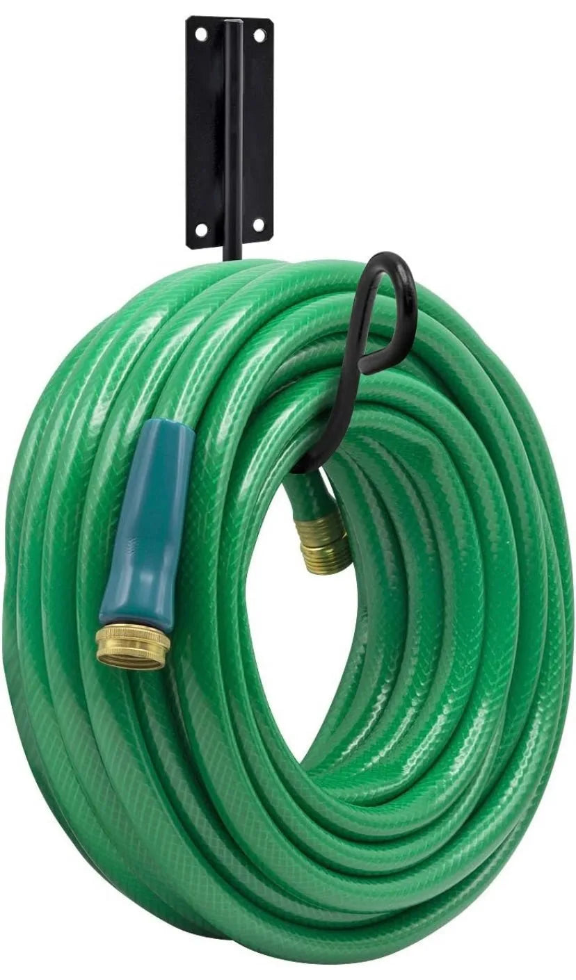 Coiled green garden hose with a nozzle on a white background