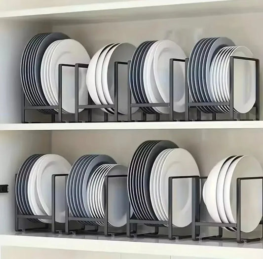 Stacked plates on metal plate racks in a kitchen cabinet.